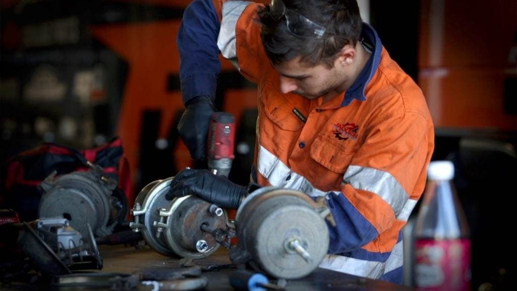 a man is repairing the truck