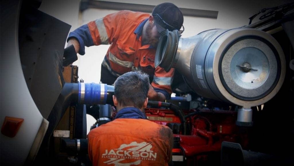 two mechanic worker is fixing the truck