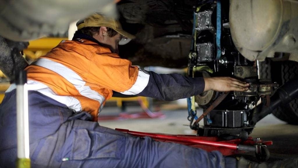 a man is repairing the truck