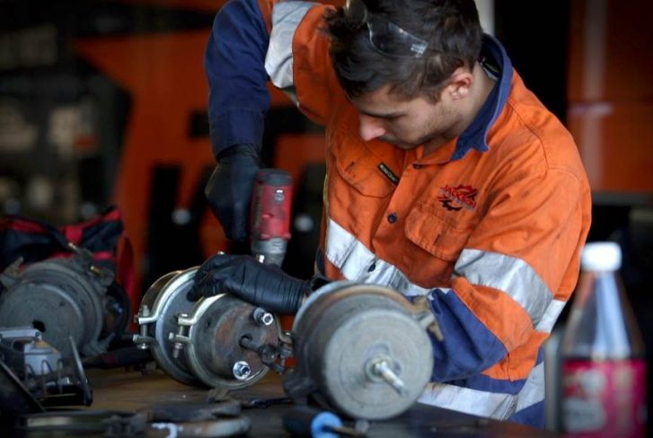 a man is repairing the truck