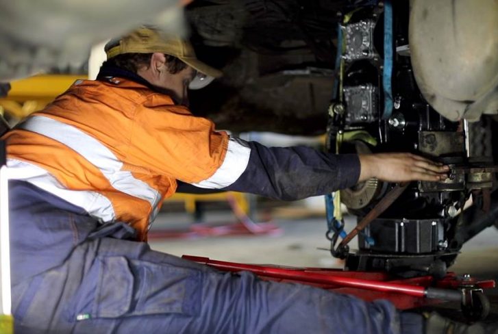 a man is repairing the truck